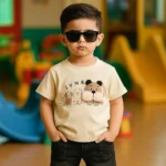 ست تابستانی تیشرت کرمی بچه‌گانه با طرح سگ و شلوارک جین مشکی