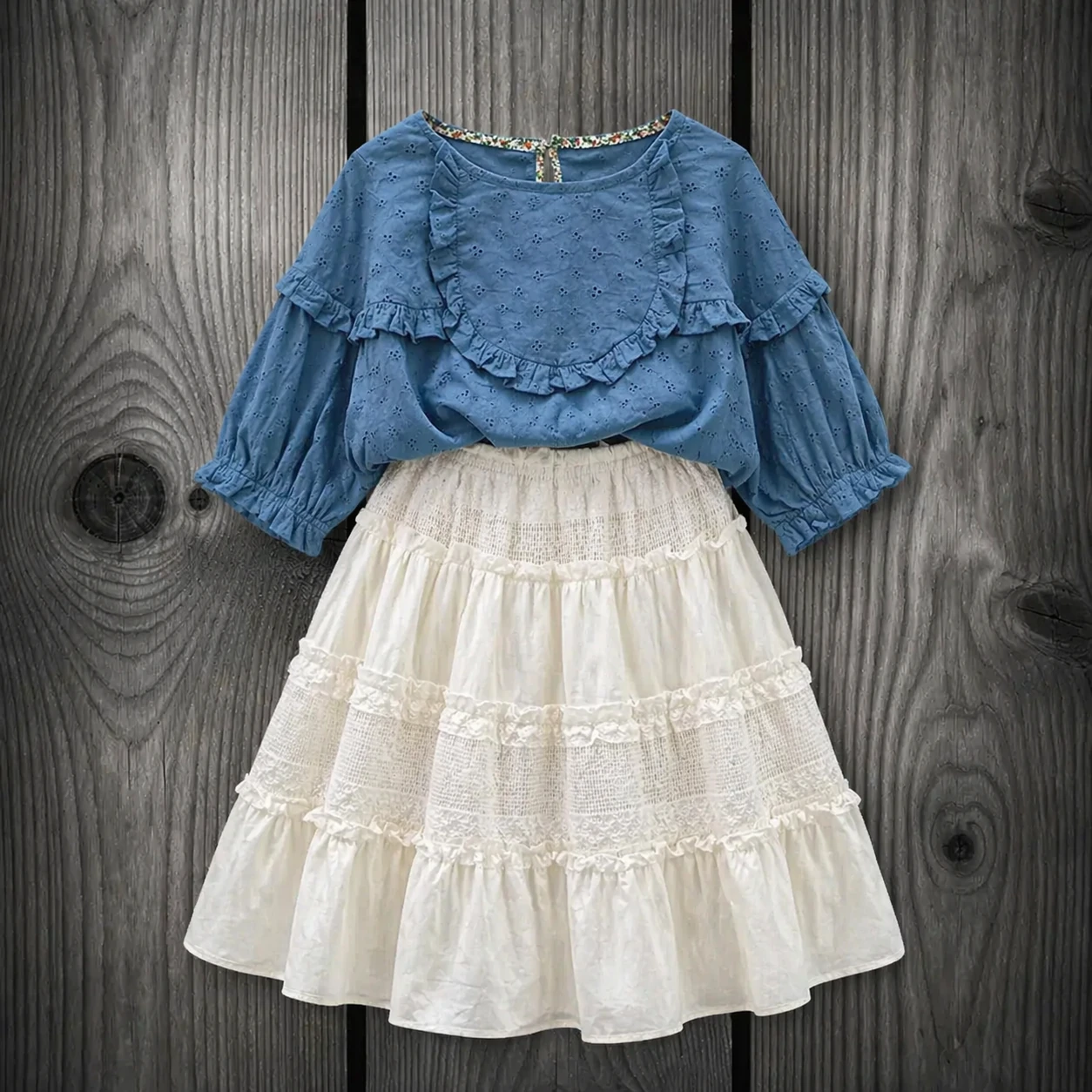 1034 girls-blue-embroidered-blouse-layered-skirt ست شومیز خامه دوزی آبی با دامن کارشده ست شومیز خامه دوزی آبی آستین پفی و دامن طبقاتی کارشده سفید کرم دخترانه